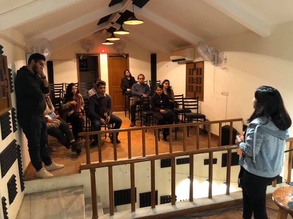 Image may contain: 2 people, people standing, people sitting and indoor