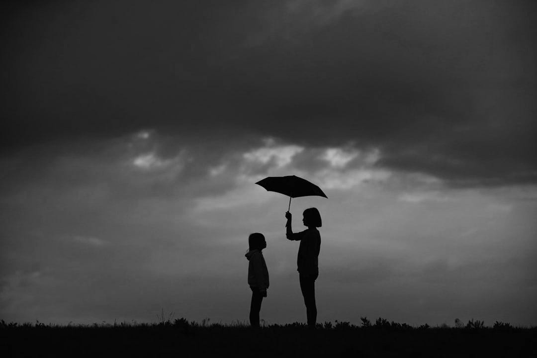 girl holding umbrella on grass field