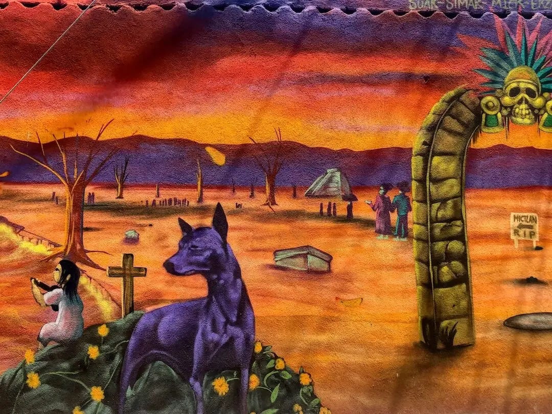 Street art - a graveyard scene with a young girl and a dog in the foreground