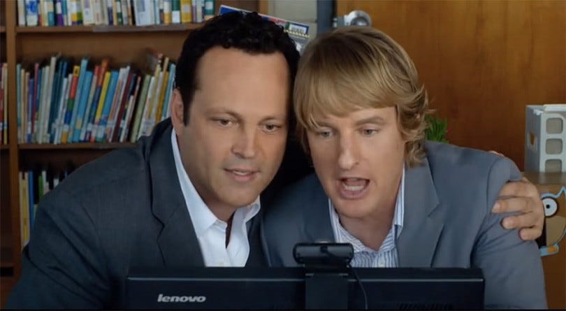 Two men intently looking at a computer during a job interview, representing technical vetting process. Two men intently looking at a computer during a job interview, representing technical vetting process.