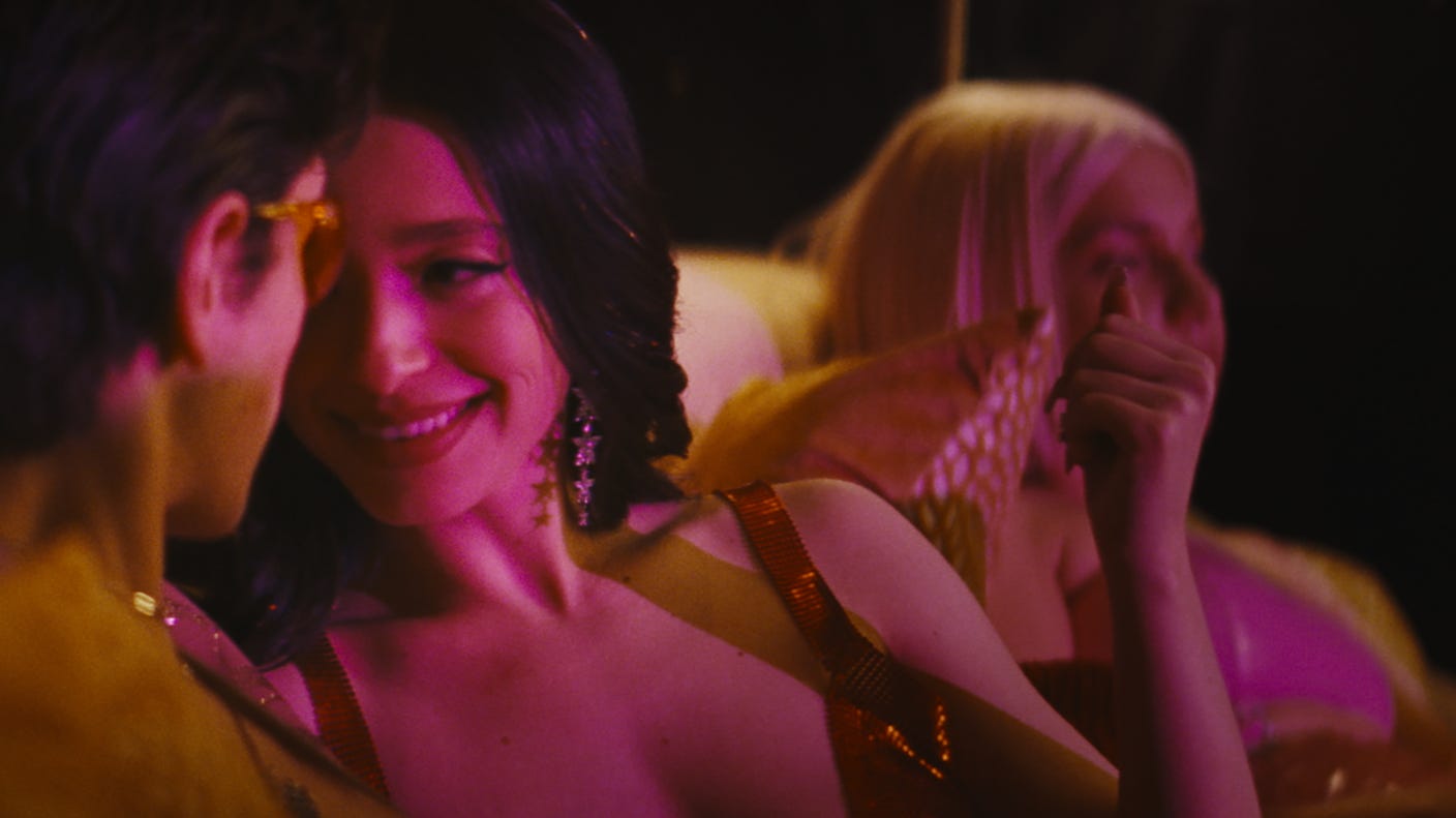 A scene from Anora, featuring Mikey Madison and two other actors in a club A scene from Anora, featuring Mikey Madison and two other actors in a club