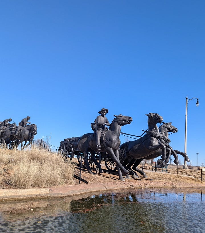 sculpture of Land Rush boomers and sooners, seen from water taxi