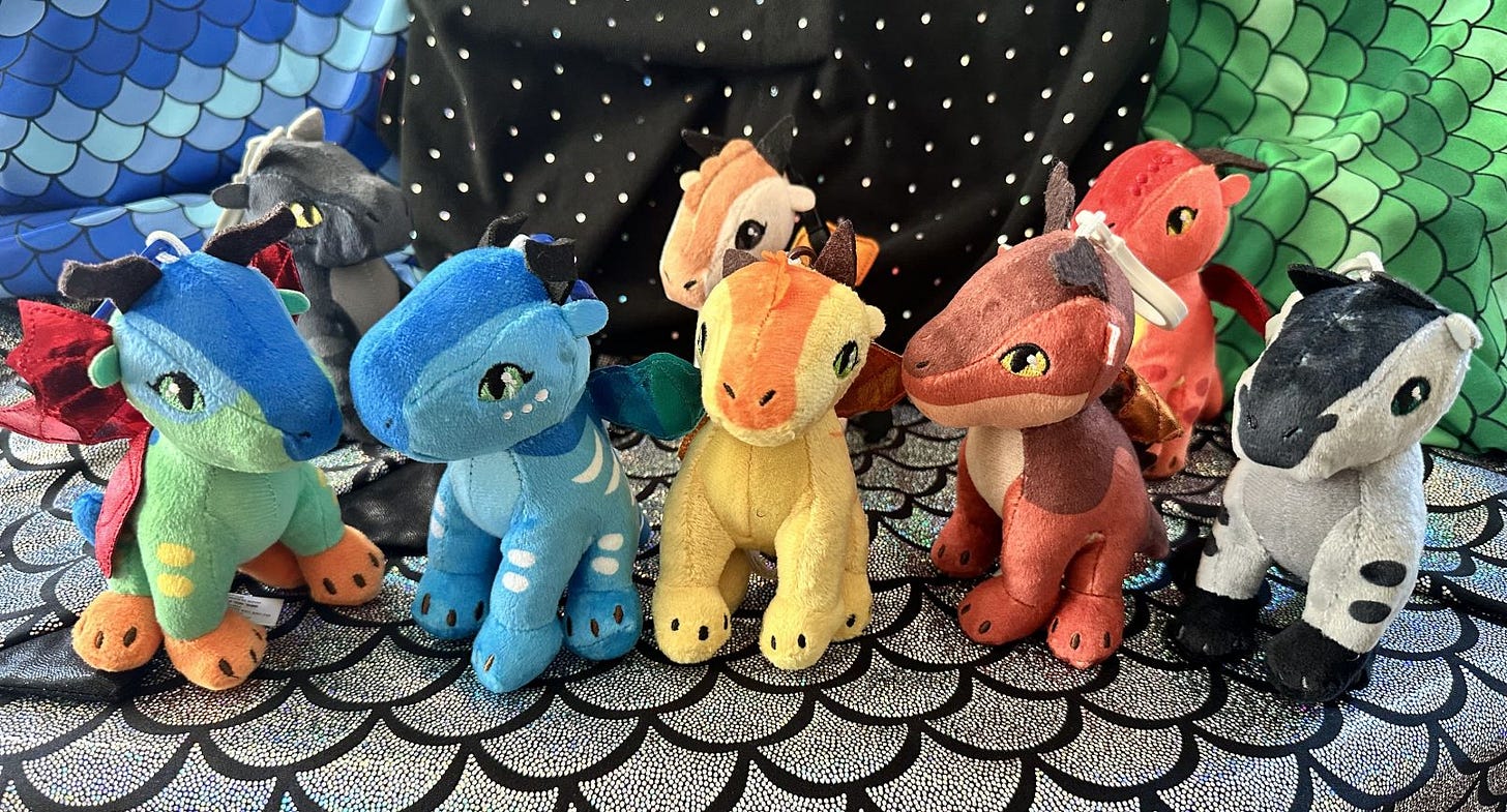 Eight small dragon keychains of the characters Glory, Tsunami, Sunny, Clay, Starflight, and (in the back row) Morrowseer, Blister, and Scarlet