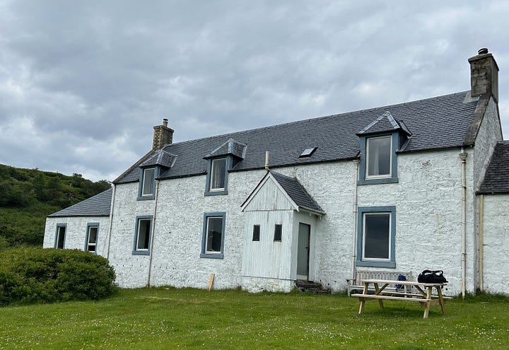 A single lane track and the white painted Barnhill farmhouse