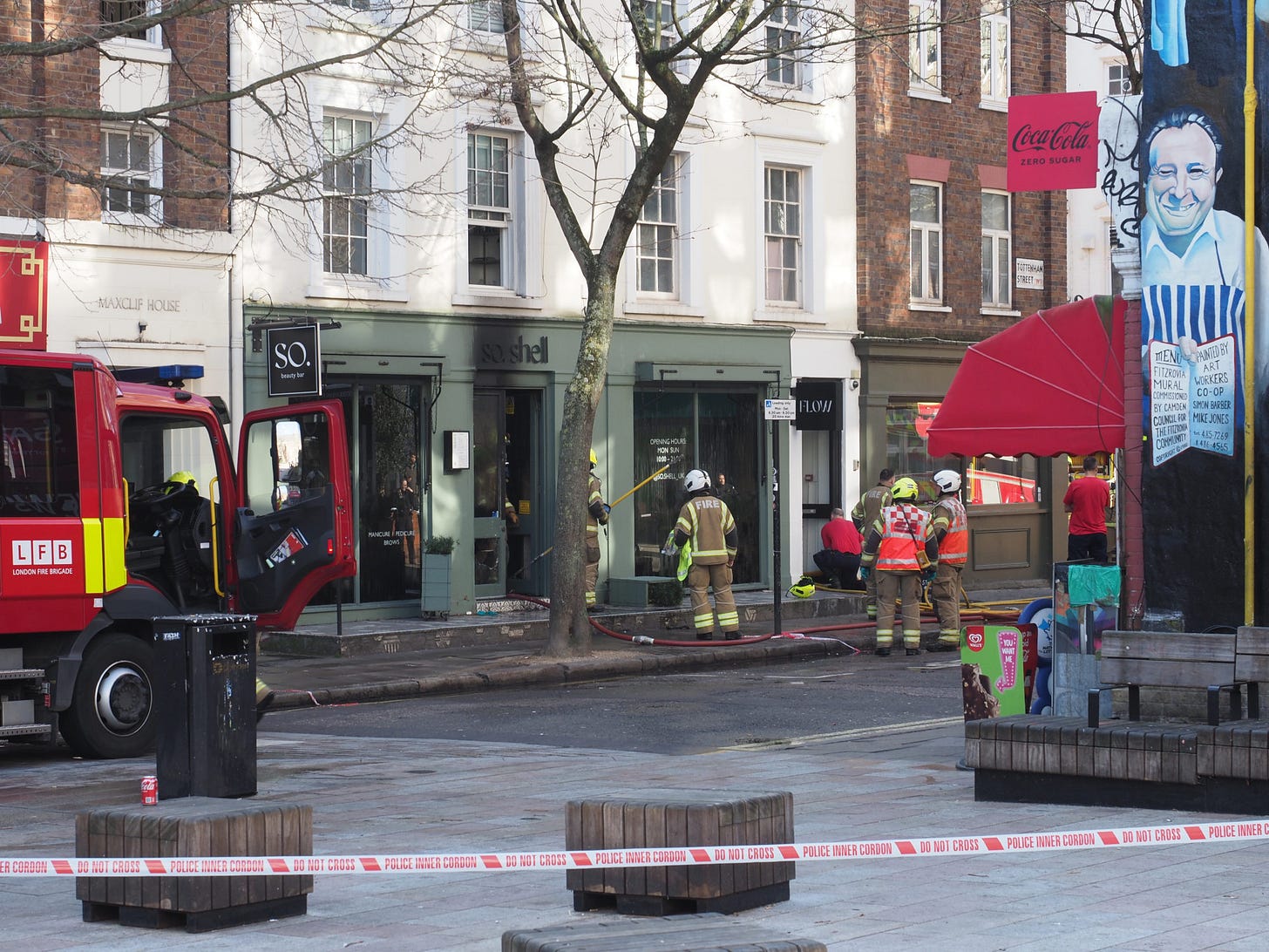 Firefighters outside building after putting out a fire.