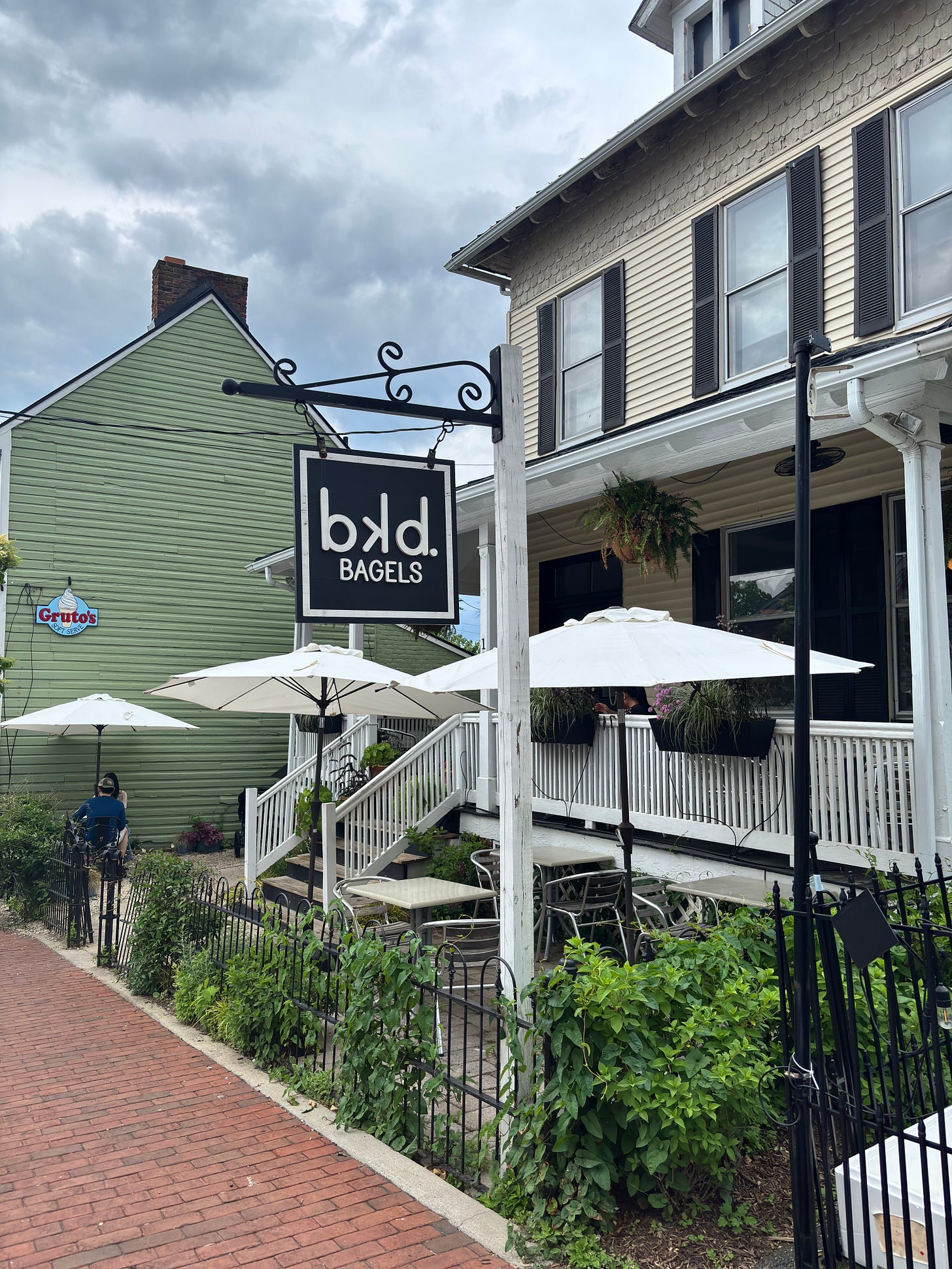 Cute patio and house containing the bkd Bagels business.