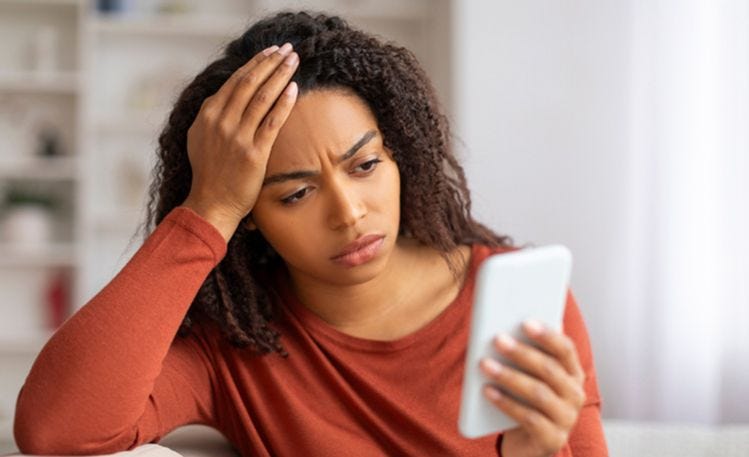 worried looking women talking on her smartphone