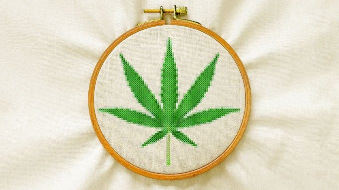 Illustration of an embroidery hoop with a marijuana leaf cross-stitched on linen. Illustration of an embroidery hoop with a marijuana leaf cross-stitched on linen.
