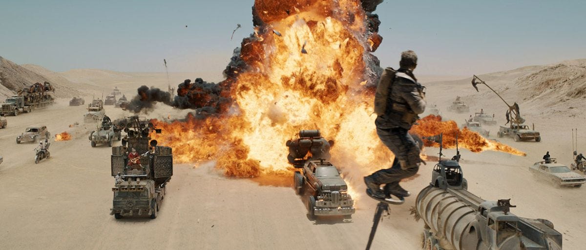 Max in Fury Road looking back at an explosion from a shifting pole