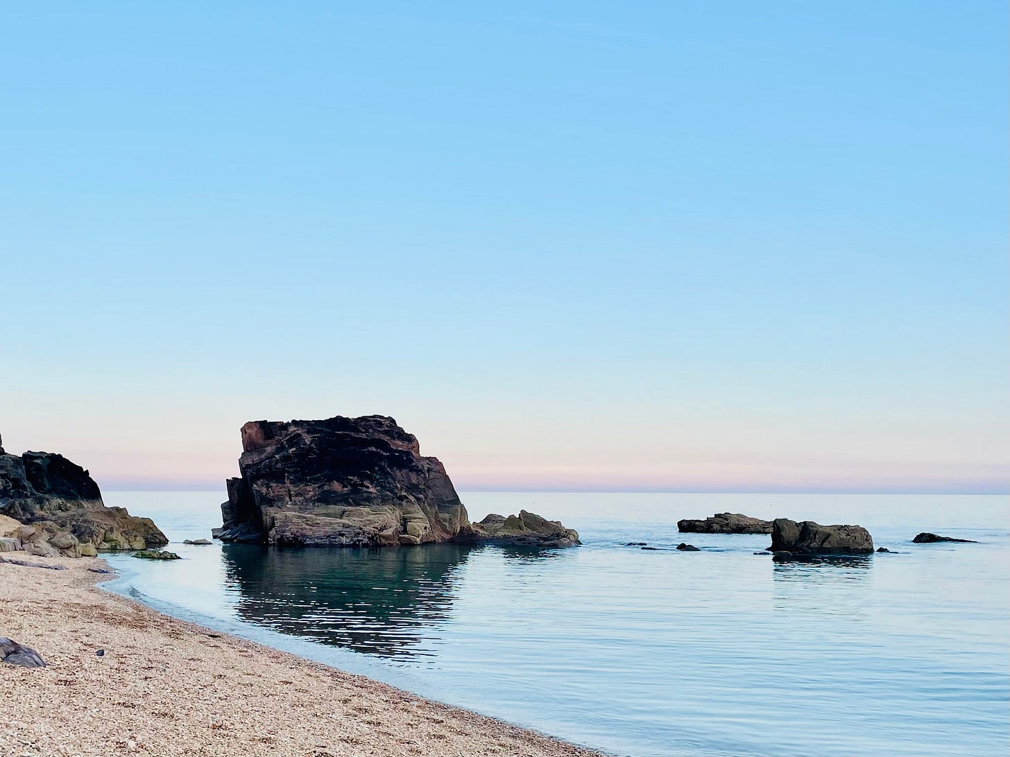 The sea and a beach at sunset