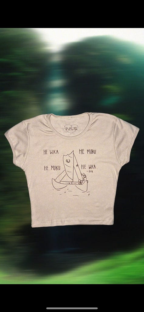 women's baby tee in tan with brown lettering and a drawing of a waʻa or Hawaiian style voyaging canoe. Wandering through the forest.