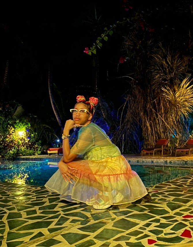 Kiana looking sad and pensive in front of a pool at night