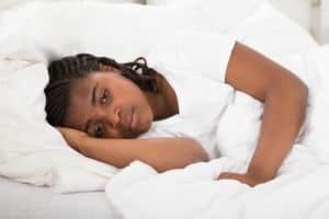 Woman lying in bed awake