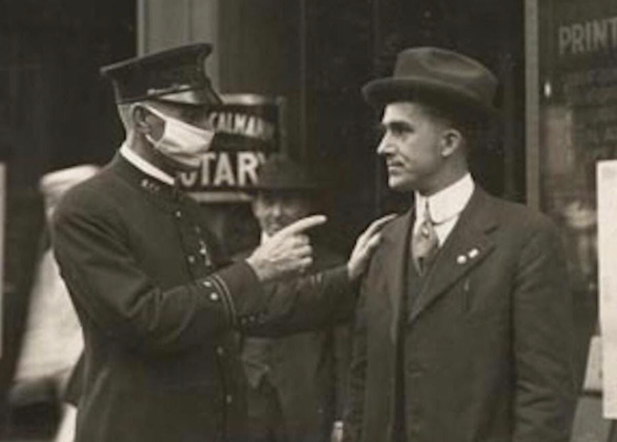 A stark reminder of public health measures: a policeman scolds a man for not wearing a mask during the 1918 influenza pandemic.