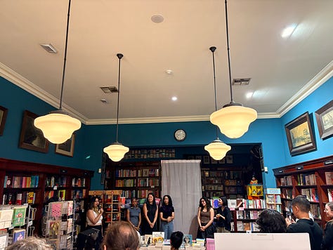 Books with signed stickers on them, a sleepy dog, and an event in a bookshop.