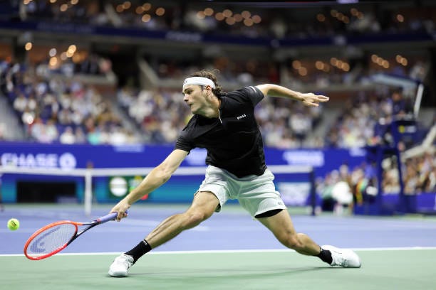 Taylor Fritz of the United States returns a shot against Frances Tiafoe of the United States during their Men's Singles Semifinal match on Day Twelve...