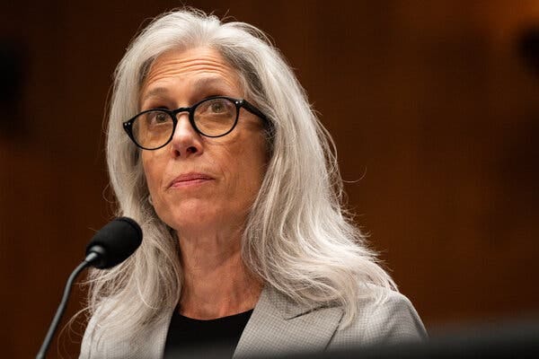 Susan Monarez with a microphone in front of her while being questioned in a Senate hearing room. Susan Monarez with a microphone in front of her while being questioned in a Senate hearing room.