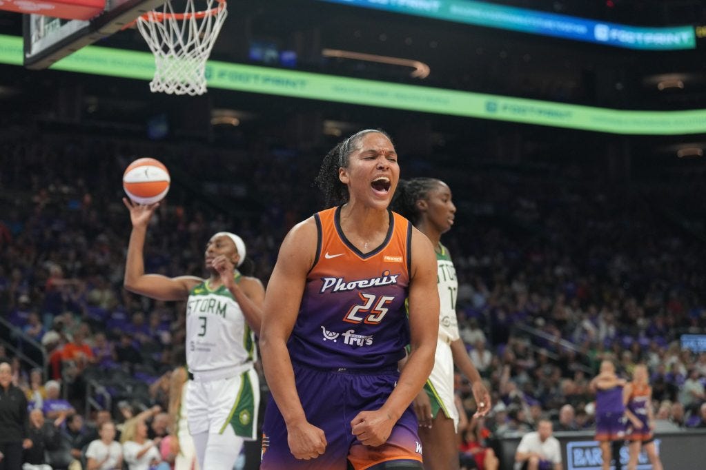 Alyssa Thomas (25) flexes her arms down and yells in celebration