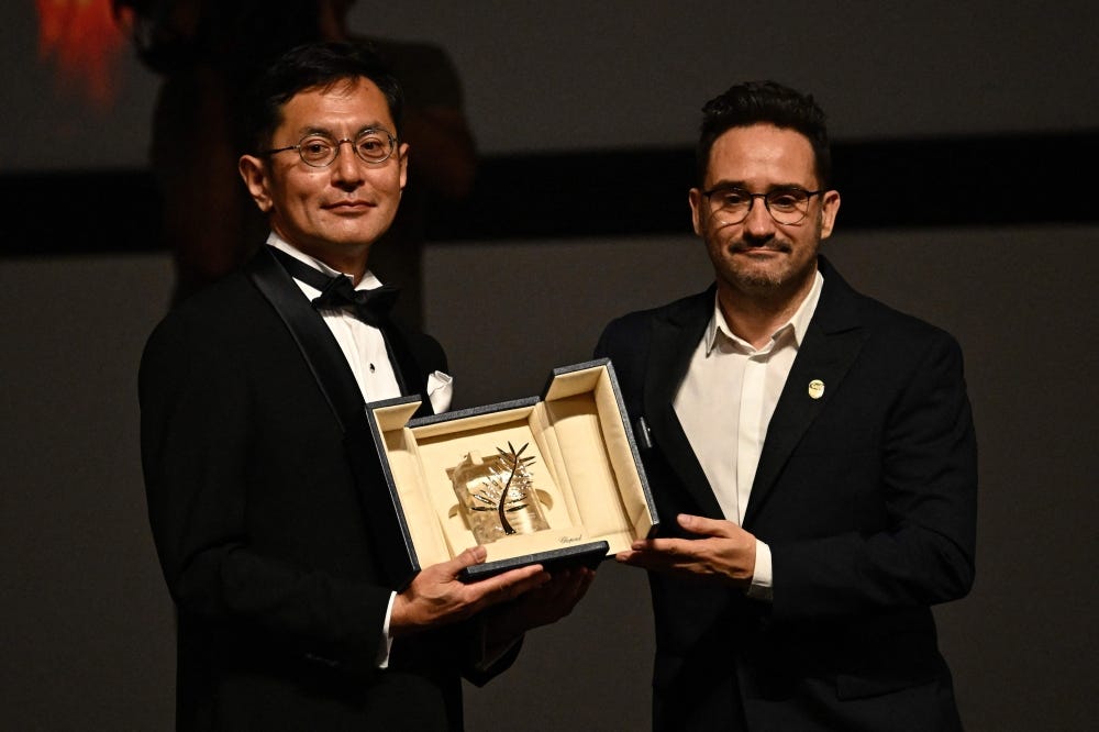 Japanese director and Ghibli Park Creative Development manager Goro Miyazaki is awarded with the Honorary Palme by Spanish director, producer, and writer and member of the Jury of the 77th Cannes Film Festival Juan Antonio Bayona during the 77th edition of the Cannes Film Festival in Cannes, southern France, on May 20, 2024. Photo by LOIC VENANCE / AFP. Japanese director and Ghibli Park Creative Development manager Goro Miyazaki is awarded with the Honorary Palme by Spanish director, producer, and writer and member of the Jury of the 77th Cannes Film Festival Juan Antonio Bayona during the 77th edition of the Cannes Film Festival in Cannes, southern France, on May 20, 2024. Photo by LOIC VENANCE / AFP.