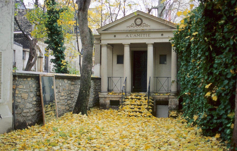 A picture of the temple of friendship with yellow leaves littered underneath on the floor. The temple is masonic, has big coloumns A picture of the temple of friendship with yellow leaves littered underneath on the floor. The temple is masonic, has big coloumns