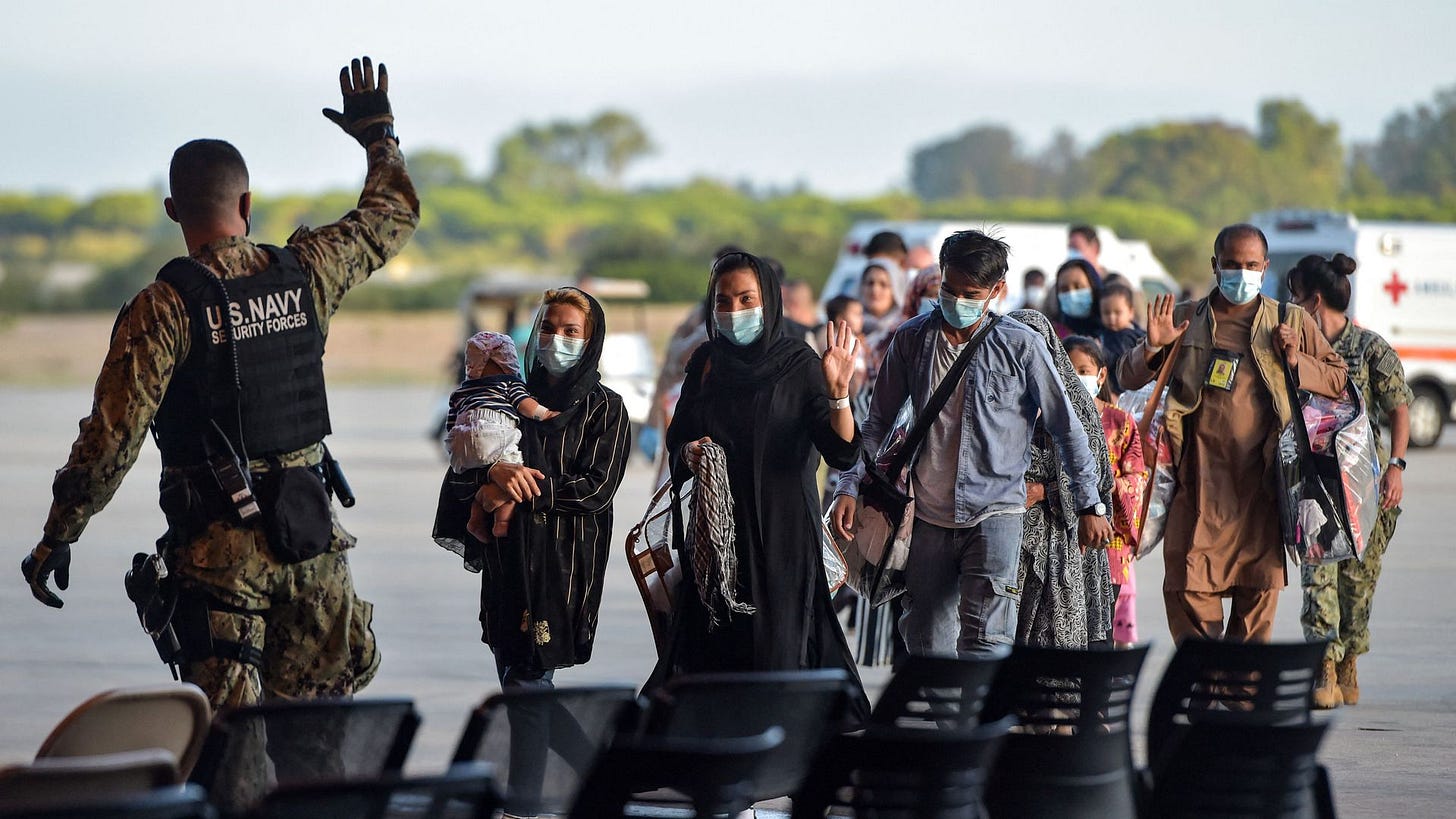Afghan refugees with U.S. navy service member