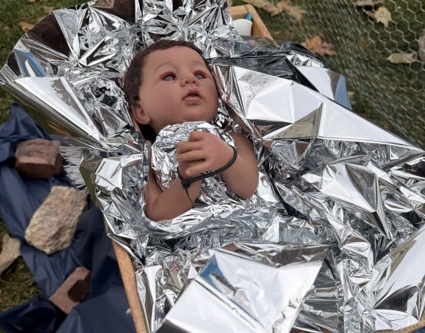 A figurine of baby Jesus in a Nativity set depicted as a youth zip-tied and covered in a thermal blanket at the Lake Street Church of Evanston. The church's leadership choose to depict the Nativity set as an homage to people facing "Operation Midway Blitz." (Jillian Westerfield)