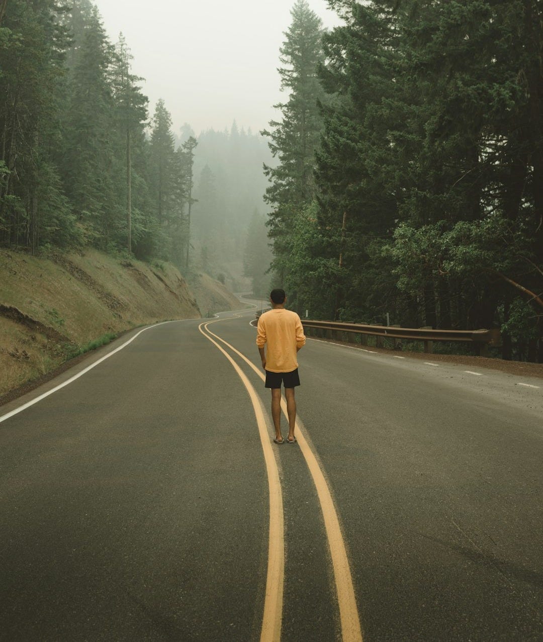 man standing at the center of the road