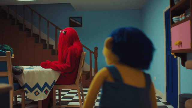 r/DHMIS - a person in a red garment sitting at a table