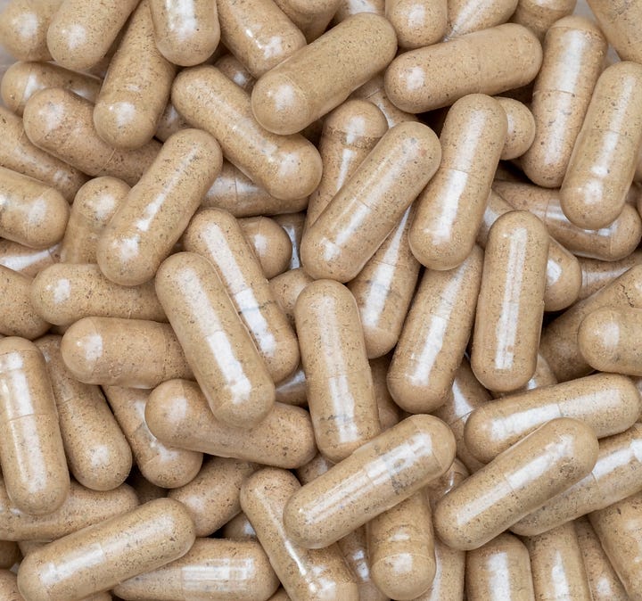 A circle of five jars containing powdered barks and capsules