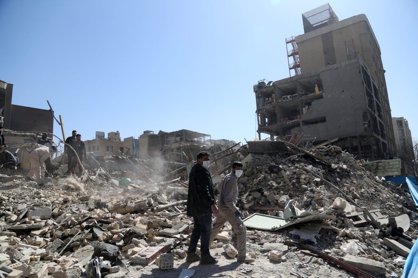 A group of people walking in front of a destroyed building
AI-generated content may be incorrect. A group of people walking in front of a destroyed building
AI-generated content may be incorrect.