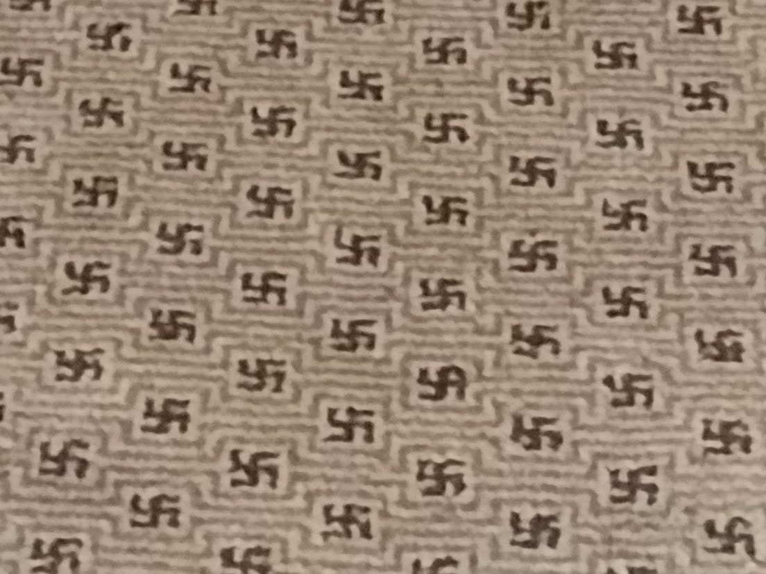 Tiny swastikas on a beige background