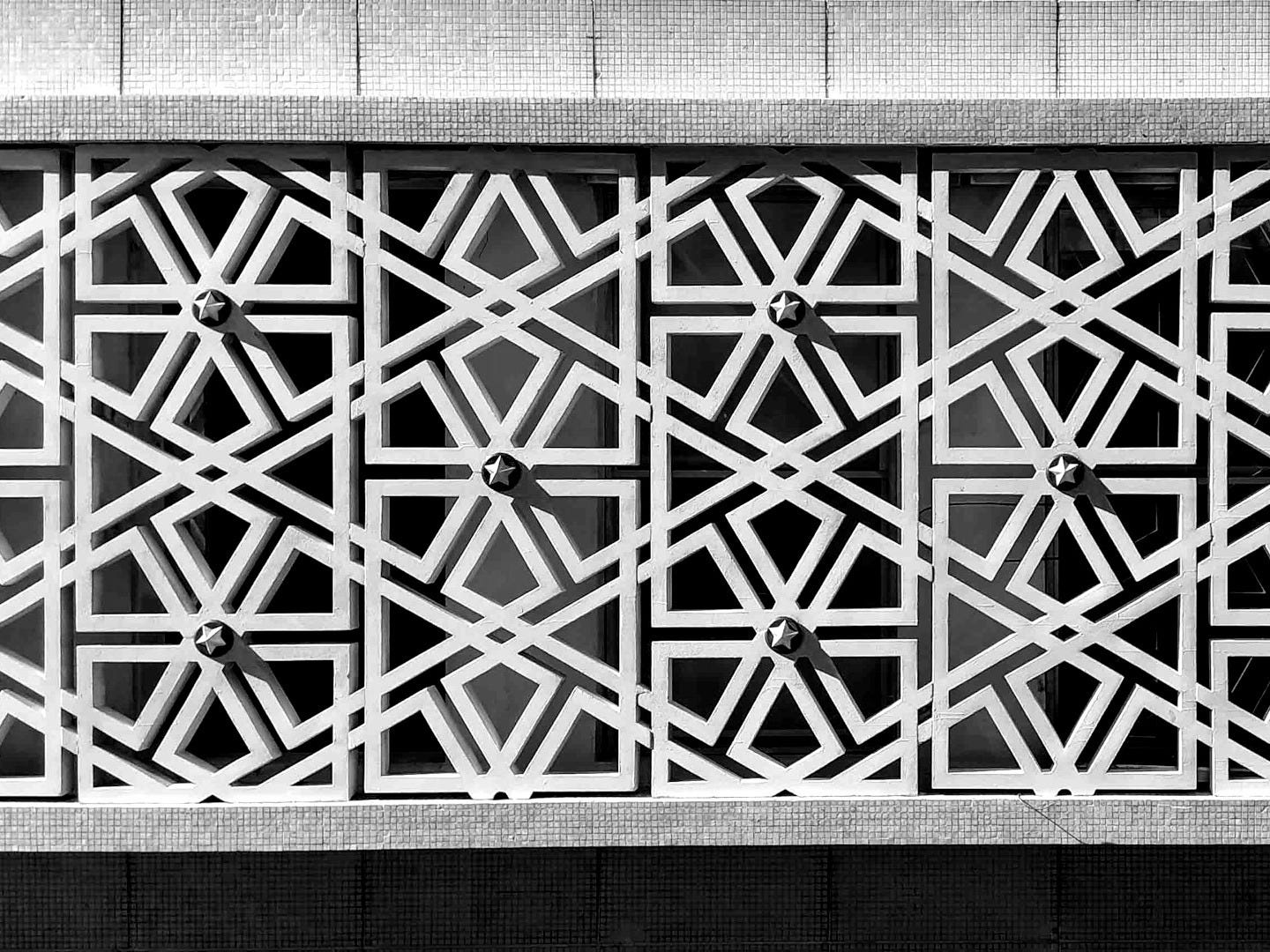a close up of a metal structure with a blue background