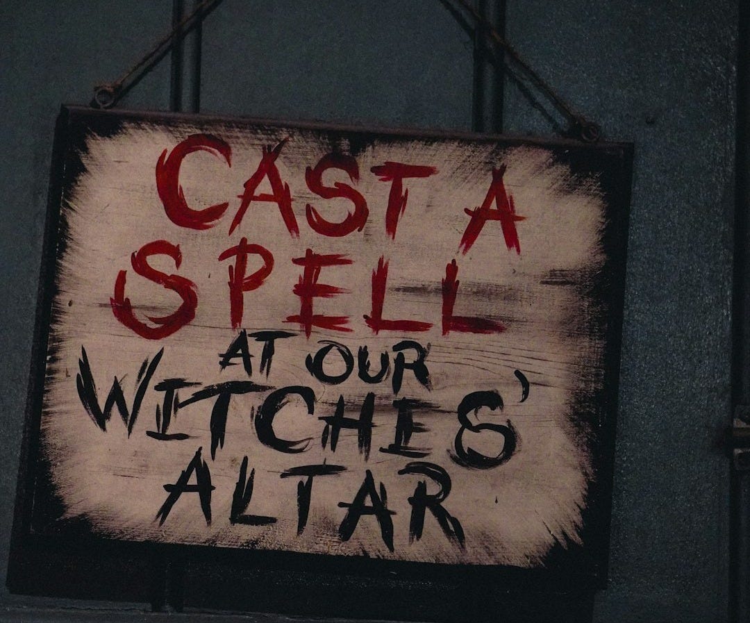 A sign that says cast a spell at our witches altar A sign that says cast a spell at our witches altar