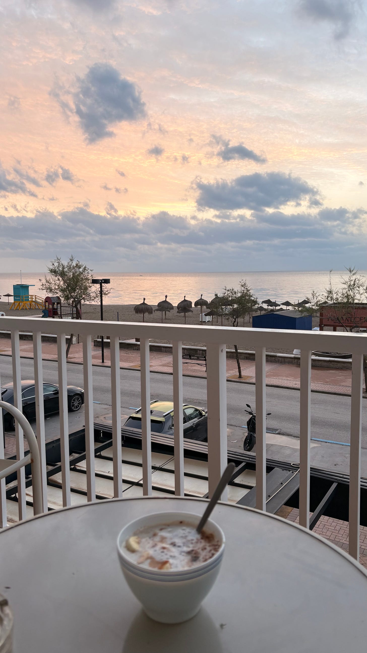 Breakfast bowl on a balcony overlooking the beach at sunrise, Fuengirola