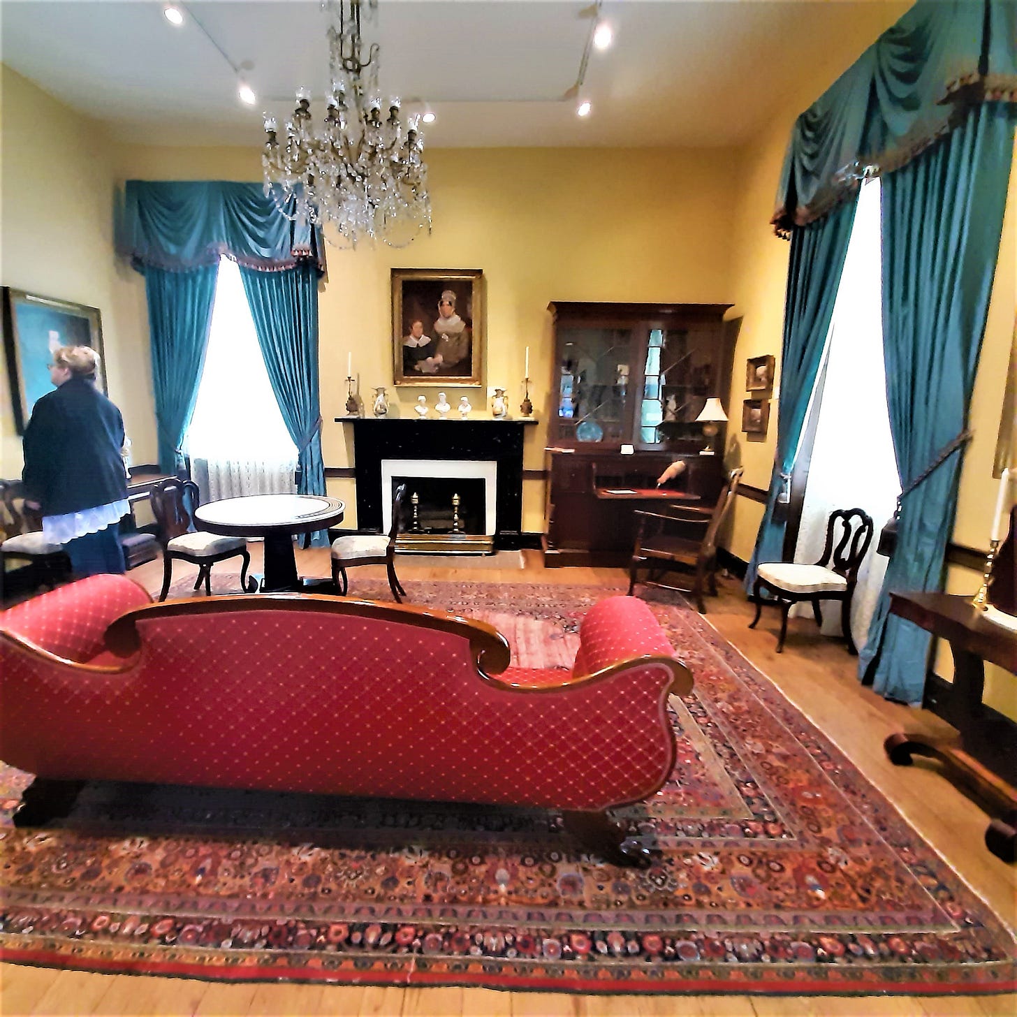 parlor in the dining room with chandelier and artwork.