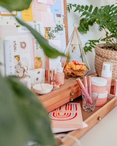 pink girly skincare products sitting on dresser