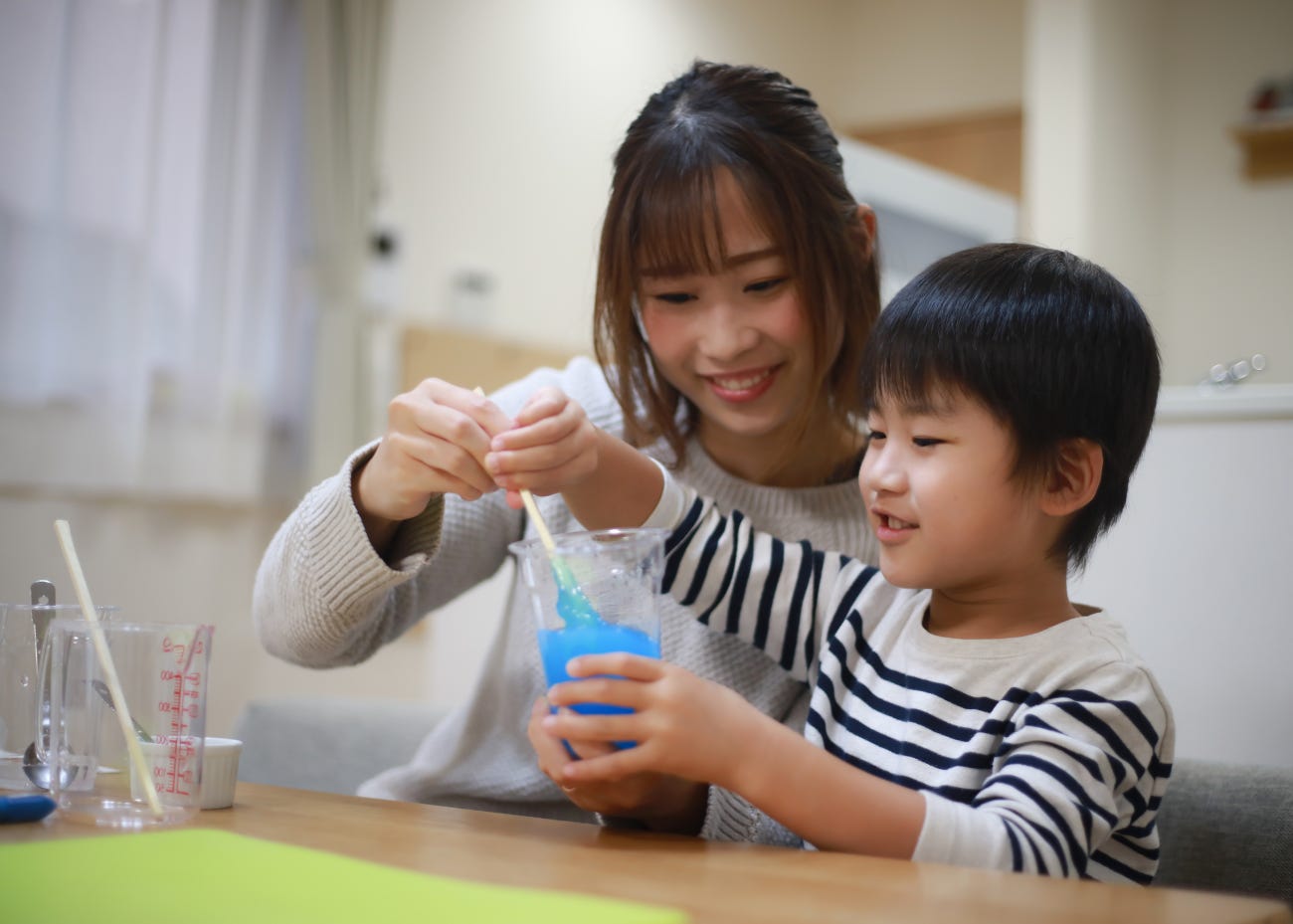 parent and child doing an experiment together
