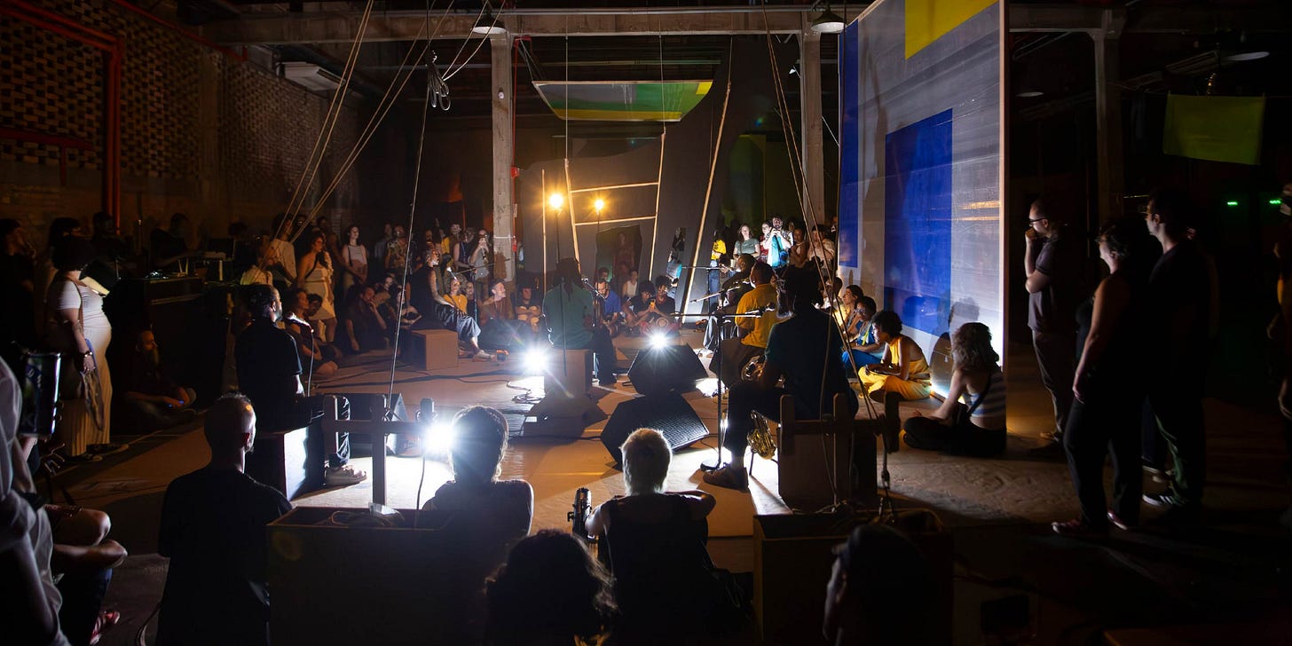 Audience watching performers on stage