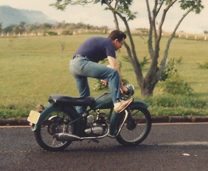 My dad goofing around with his dad's motorcycle.