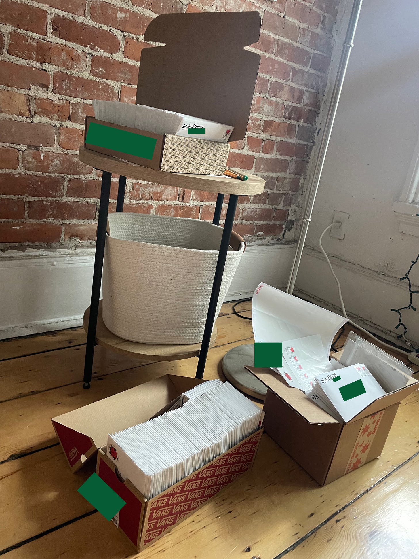 three cardboard boxes filled with envelopes