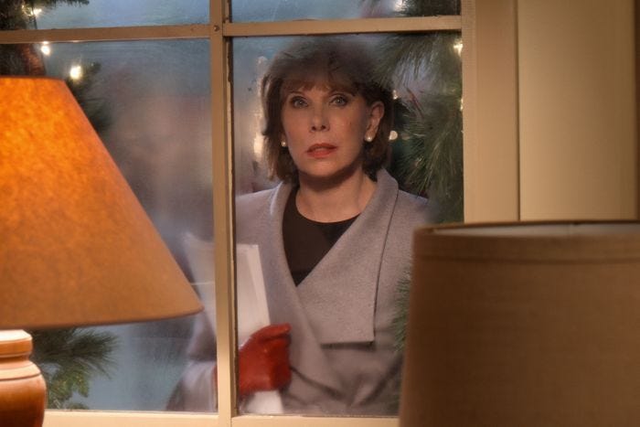 Christine Baranski looking through a window