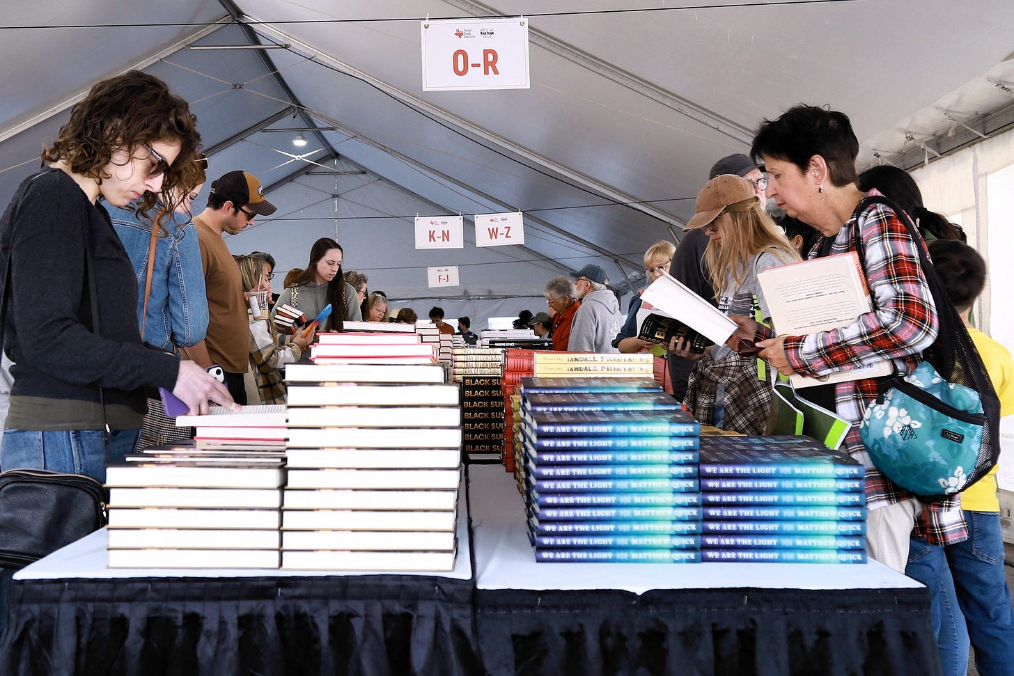 Readers browsing books in a tent at the Texas Book Festival in Austin