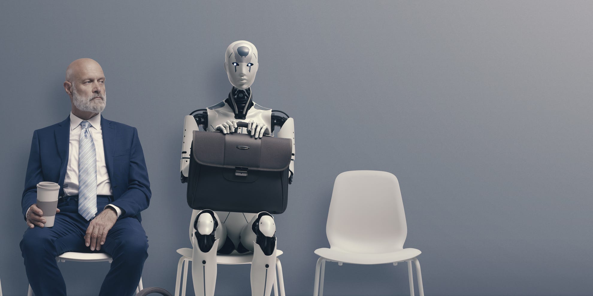 Man sitting next to a robot representing AI replacing writers.