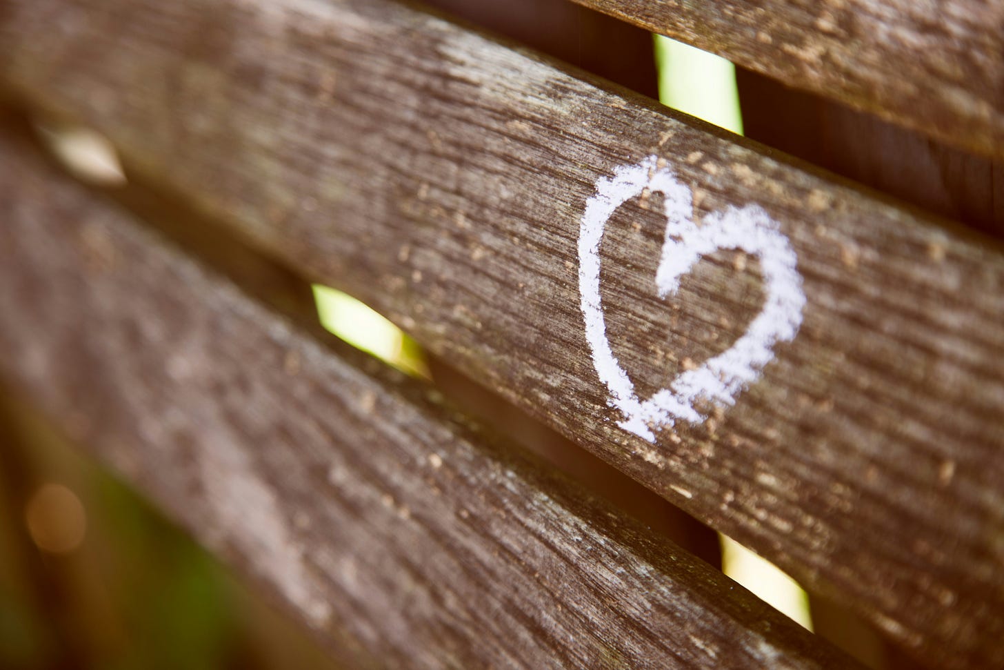 White chalk outline of a heart on a horizontal board. White chalk outline of a heart on a horizontal board.