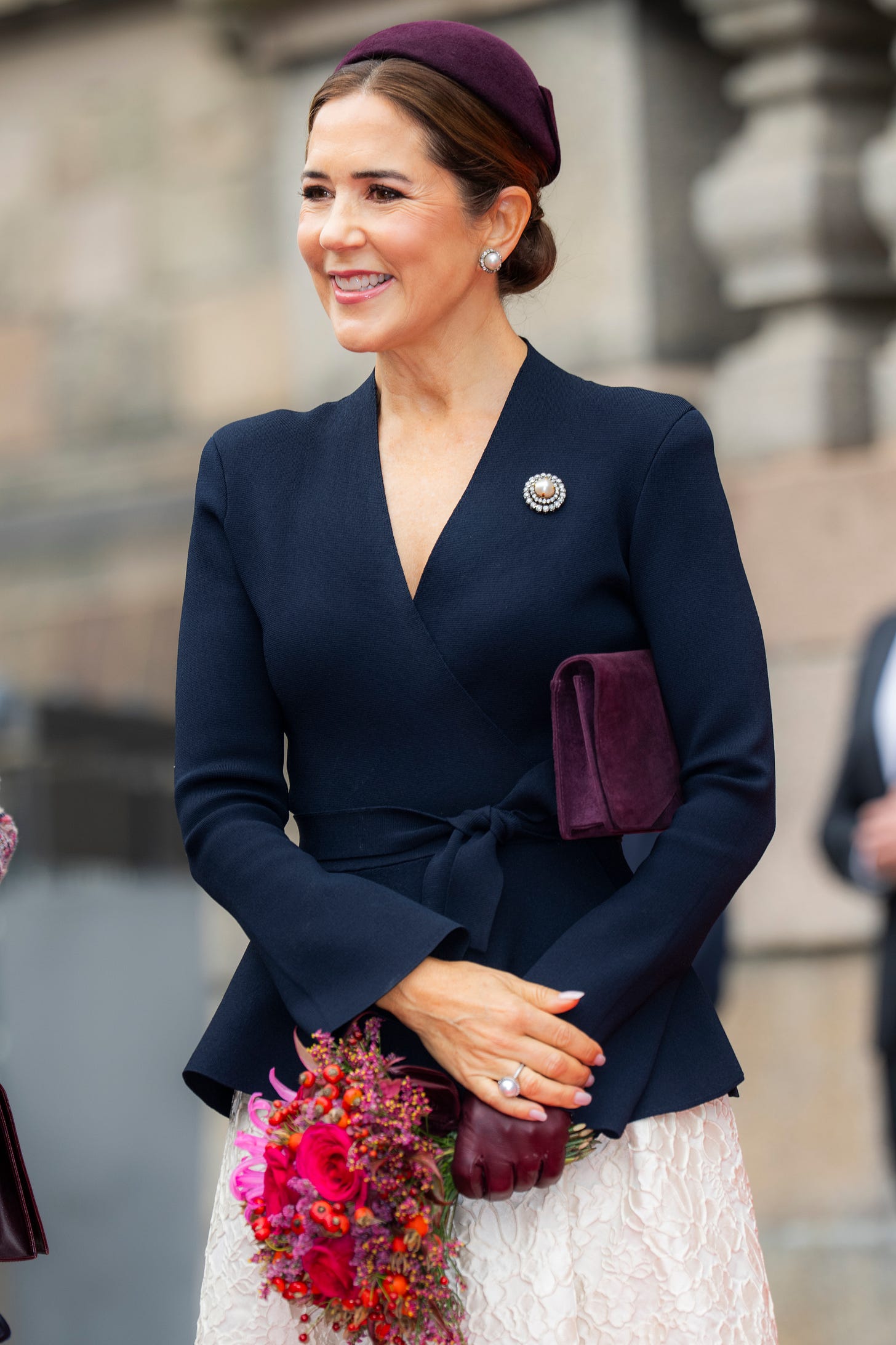Queen Mary smiling in a navy coat Queen Mary smiling in a navy coat