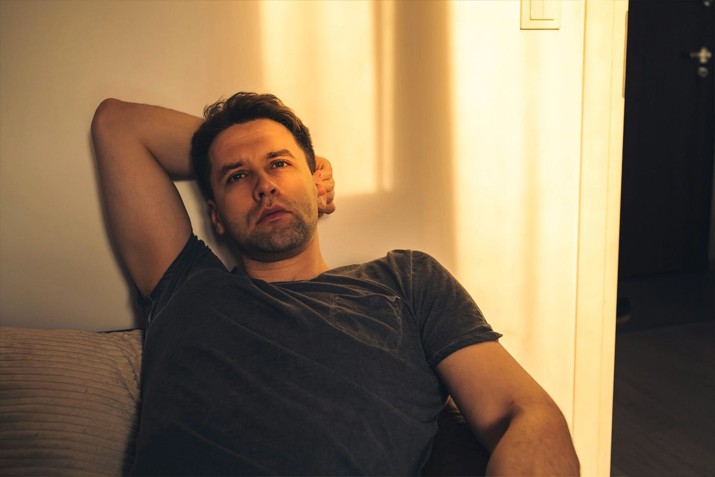 Thoughtful man leaning against a wall while considering what setting boundaries teaches us