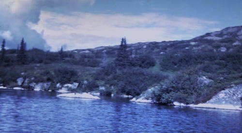 A cerulean-tinted image depicting an open lake such as a float plane might land on.