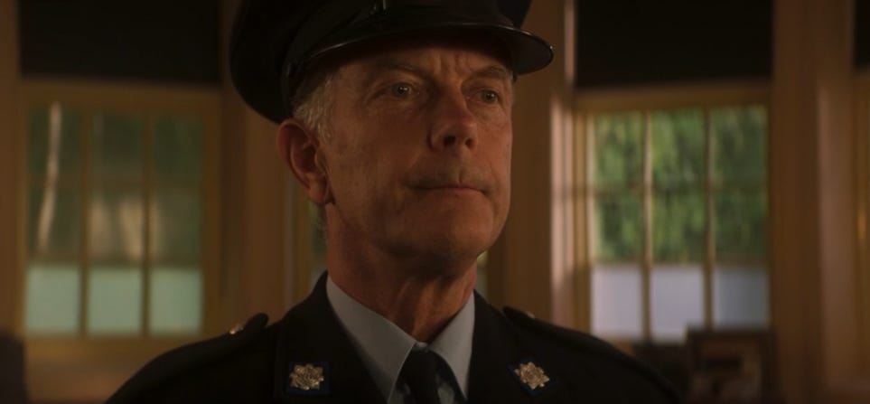 This image from "Ascension of the Cybermen" (Doctor Who Series 12's ninth episode) shows the aged Brendan on the day of his retirement from the police force. The grey-haired Brendan stands at attention while being thanked by his off-screen commander. This image from "Ascension of the Cybermen" (Doctor Who Series 12's ninth episode) shows the aged Brendan on the day of his retirement from the police force. The grey-haired Brendan stands at attention while being thanked by his off-screen commander.