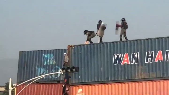Pakistan police push man off 25ft shipping containers at Imran Khan protest