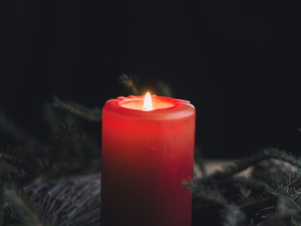 a lit candle sitting on top of a table